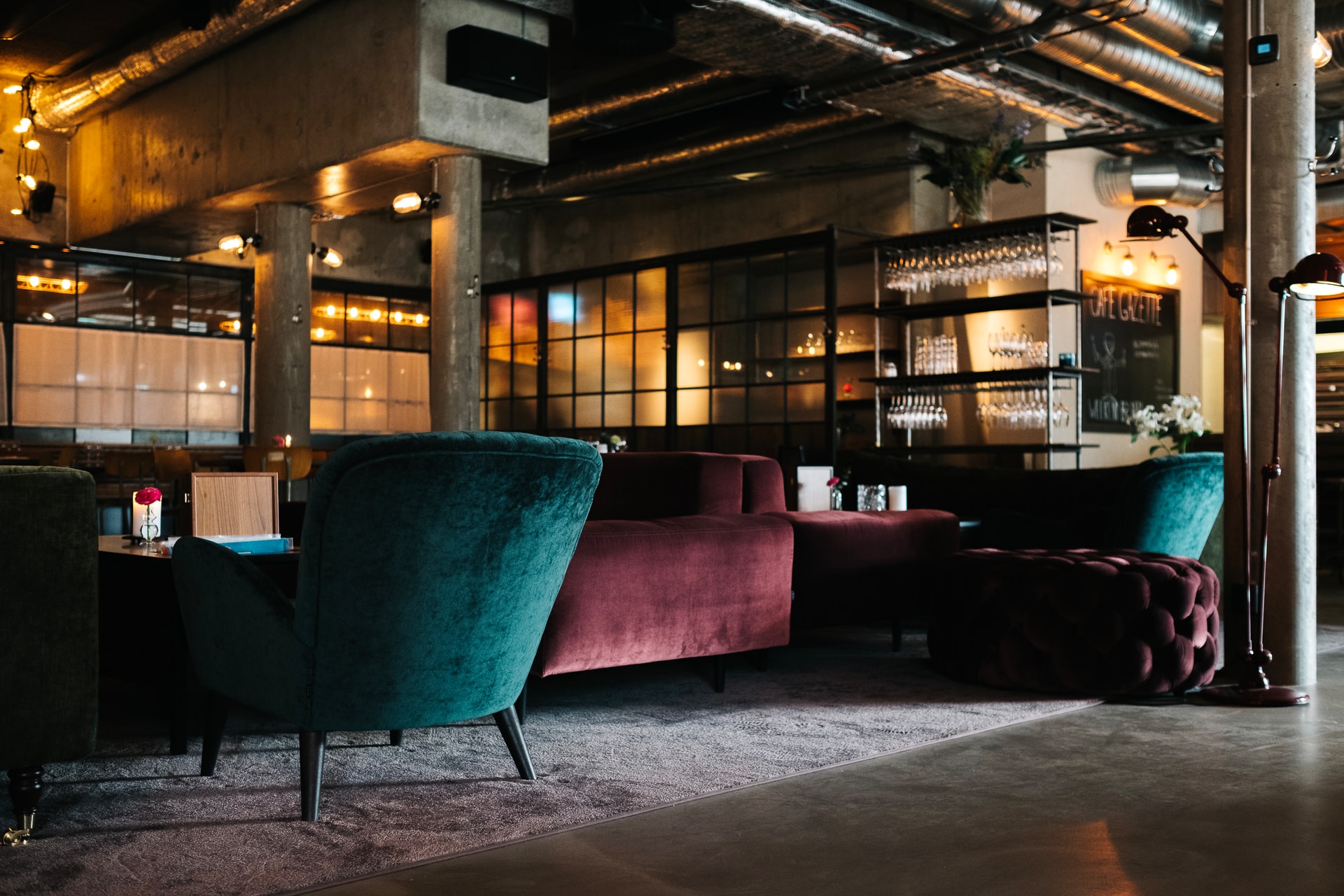 maroon and teal suede couches under brown roof